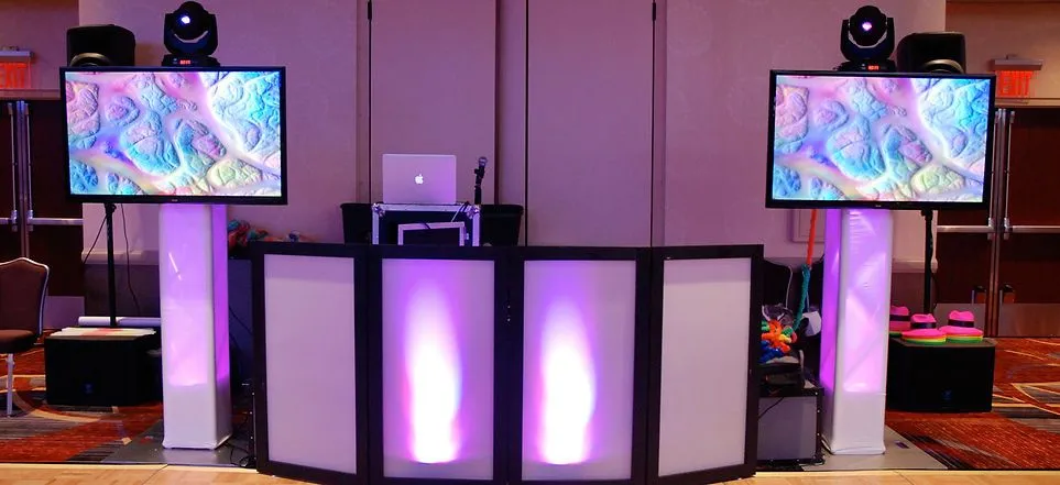 Let Us Entertain You DJ booth setup with uplighting
