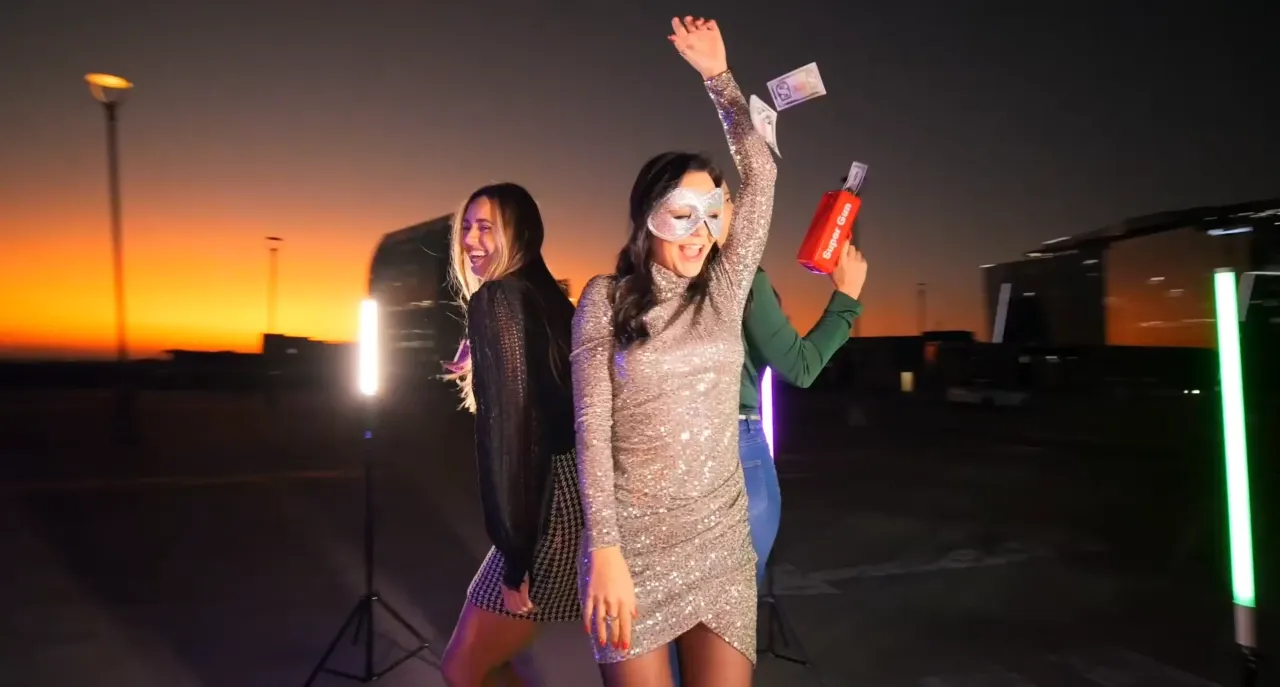 Guests dancing on a Let Us Entertain You 360 video booth at an outdoor evening event