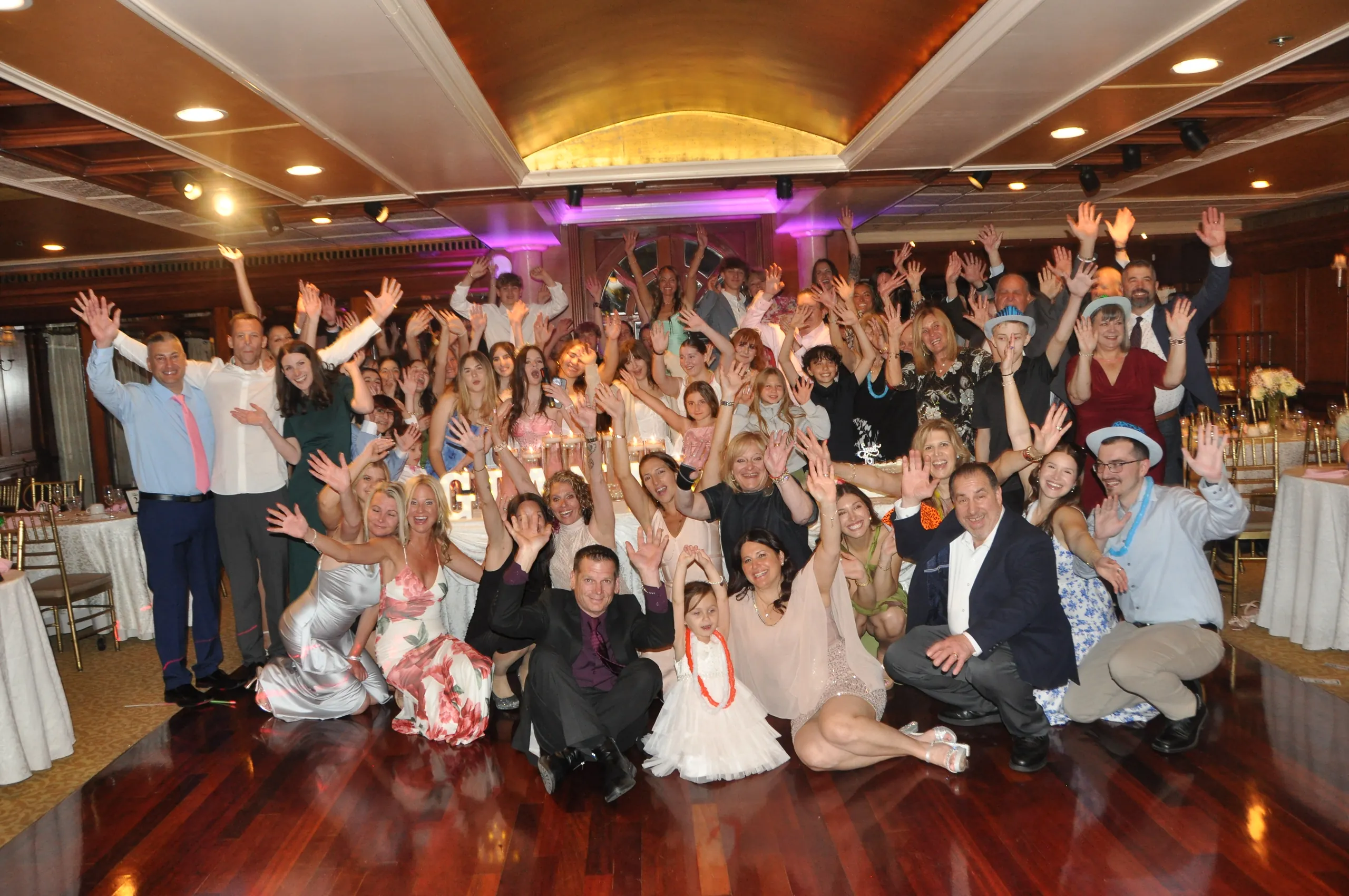 Sweet 16 guests cheering on the dance floor at a Long Island catering hall