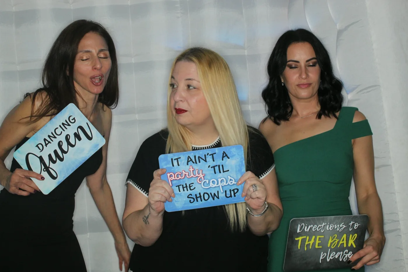 Wedding guests with props in the open-air photo booth
