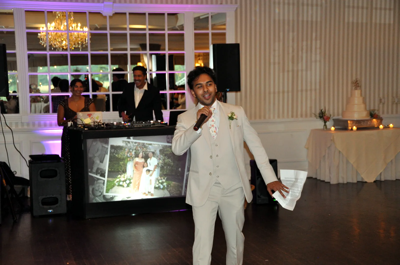Toast at the DJ booth with the live photo screen at a Long Island wedding